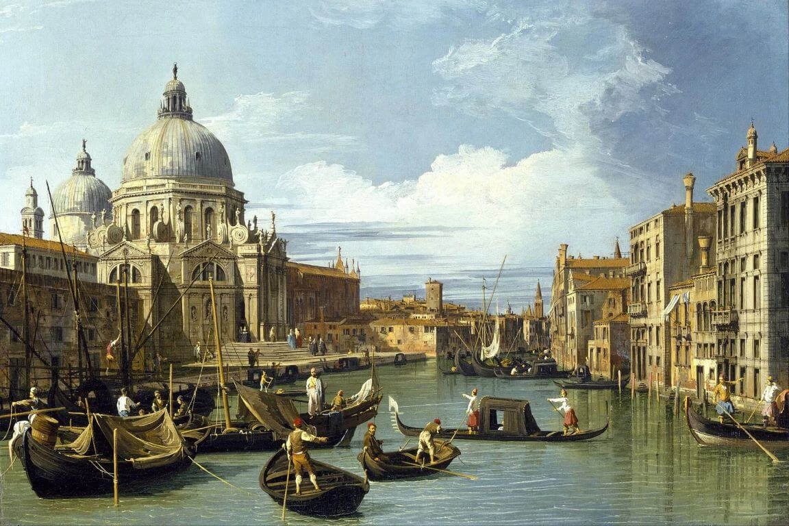 The Grand Canal in Venice with gondolas on the water and buildings on both sides.